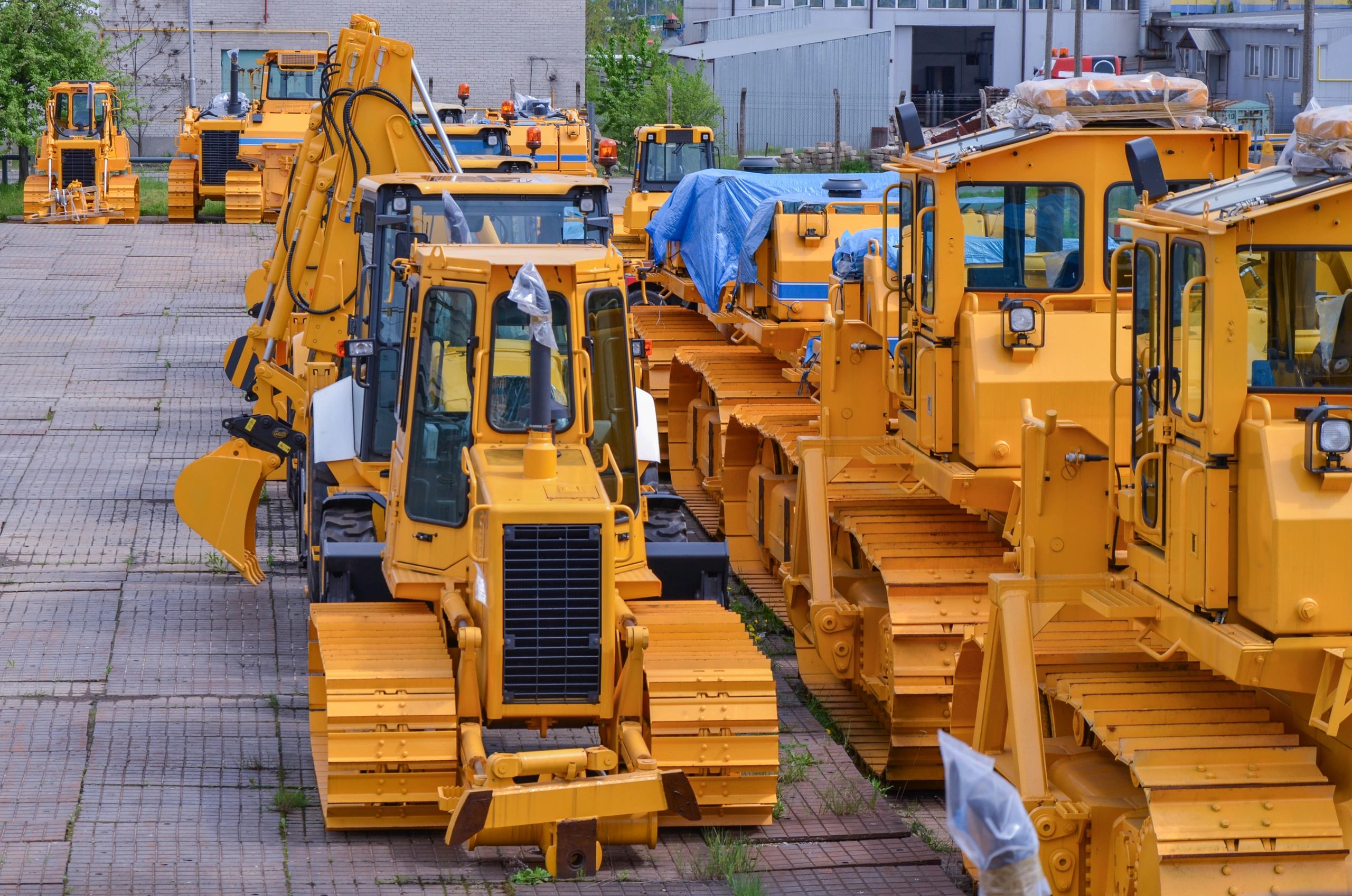 A storage yard with a lot of construction equipment.